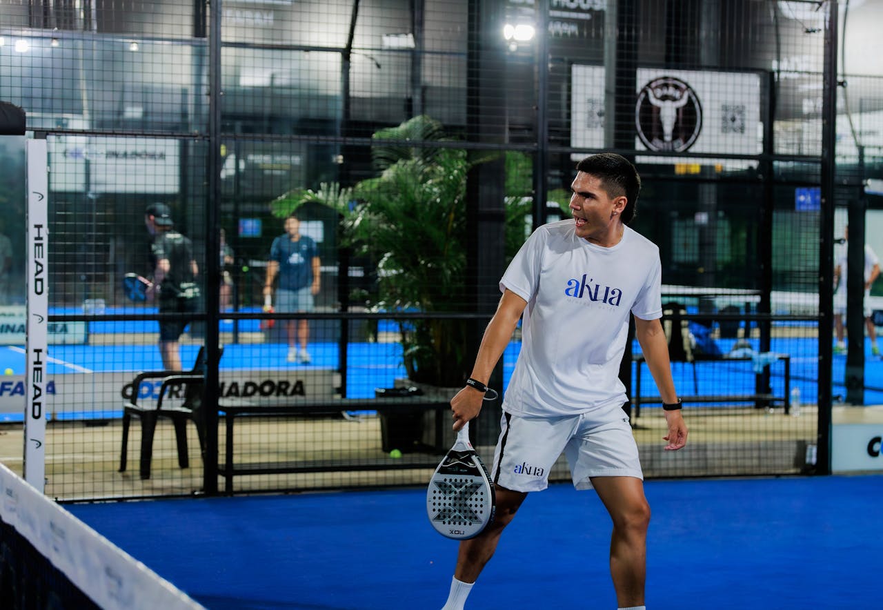 Crafting Captivating Headlines: Your awesome post title goes here Energetic padel tennis player at indoor court mid-match.